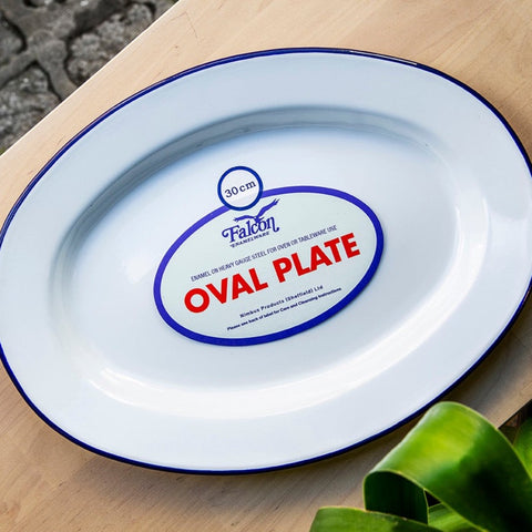photo shows white enamel oval plate with blue rim
