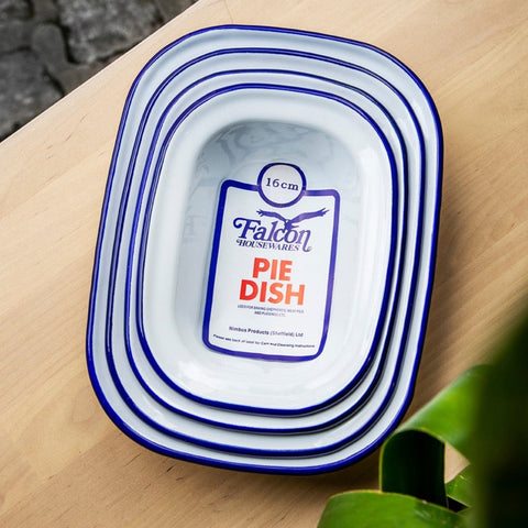 photo shows a stack of white enamel pie dishes with blue rim