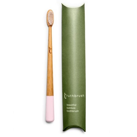Photo shows a bamboo toothbrush in petal pink colour