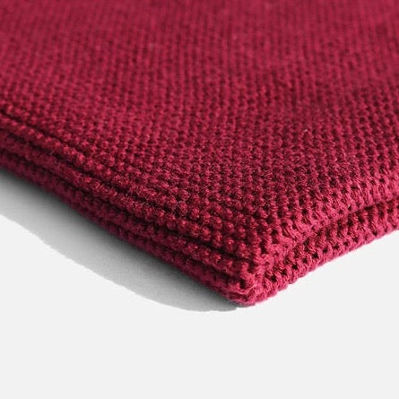Close up of organic cotton dish cloth in plum red